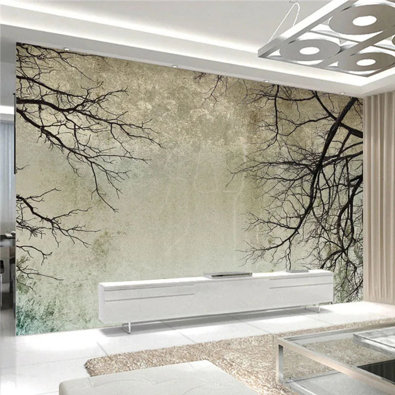 Papier peint effet chaux grège et branches nues : effet chaux grège patinée et branches nues, posé dans un salon