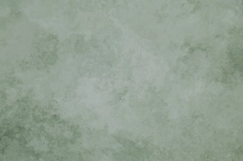 Papier peint effet béton ciré vert sauge : vue du motif, béton ciré vert sauge aux nuances douces et nuageuses