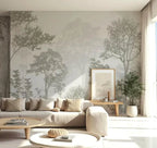 Papier peint panoramique Forêt brumeuse gris sauge : grands arbres gris sauge dans la brume, posé dans un salon