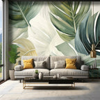 Papier peint panoramique Grandes feuilles vert sauge : grandes feuilles de monstera vert sauge et vert bouteille sur fond crème, posé dans un salon