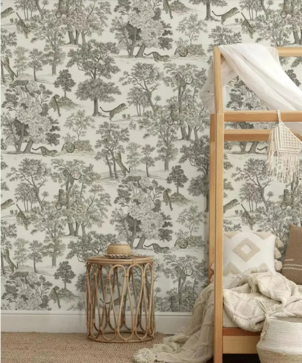 Papier peint panoramique Toile de Jouy aux tigres : sous-bois gravé à l'encre sur fond crème, tigres cachés dans les arbres, posé dans une chambre d'enfant