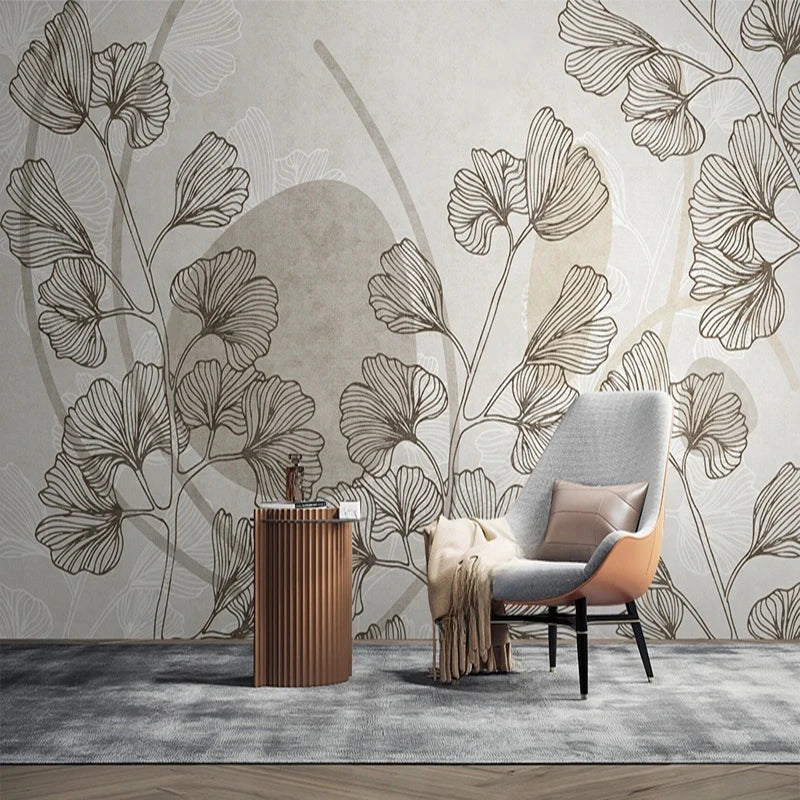 Papier peint panoramique Feuilles de ginkgo et formes sable : feuilles de ginkgo et formes sable près d'un fauteuil gris