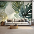 Papier peint panoramique Grandes feuilles vert sauge : grandes feuilles de monstera vert sauge et vert bouteille sur fond crème, posé dans un salon