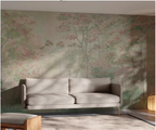 Papier peint panoramique Sous-bois fleuri vintage : forêt peinte aux feuillages vieux rose et vert passé, posé dans un salon