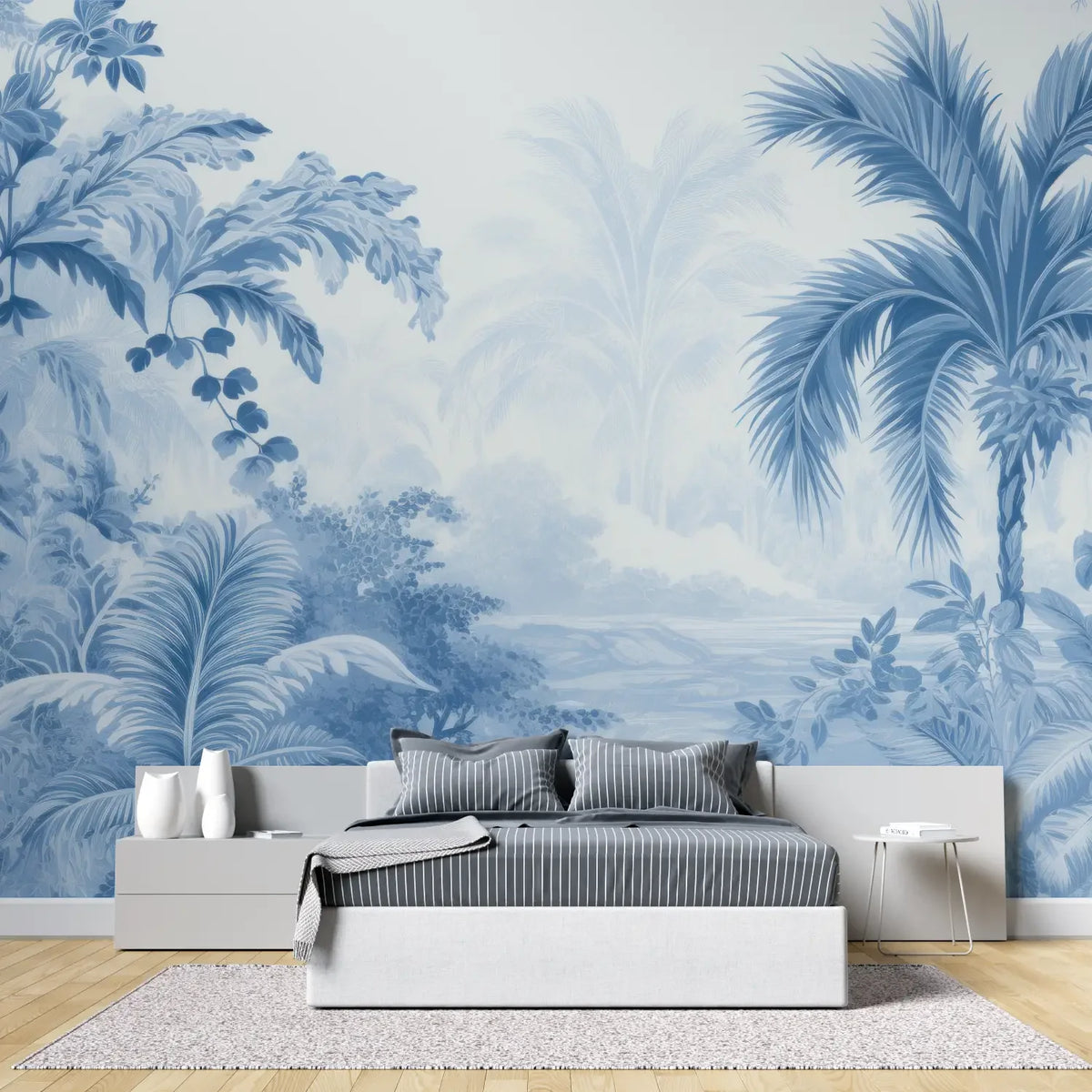 Papier peint panoramique Jungle gravée bleue : palmiers, bananiers et feuillages gravés en bleu porcelaine sur fond blanc, derrière un lit