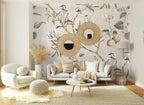 Papier peint panoramique Branches fruitières et oiseaux lin posé sur le mur d’un salon
