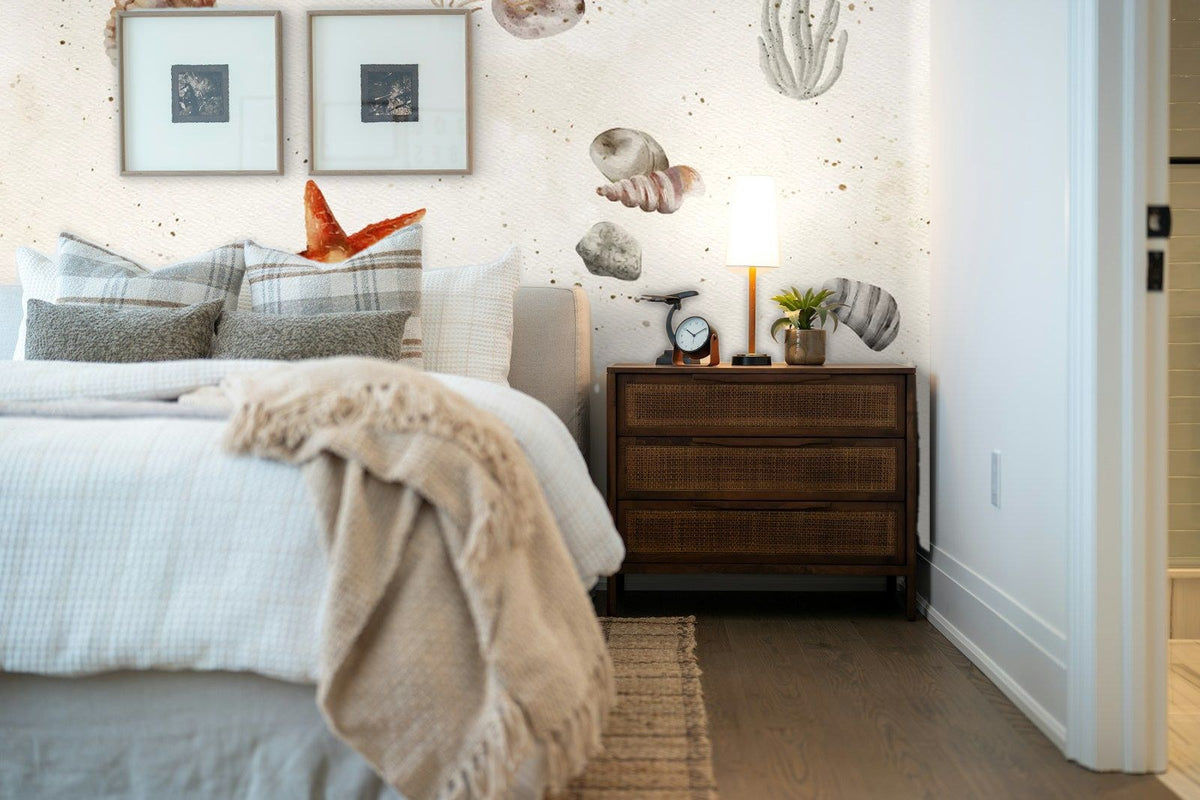 Papier peint panoramique Coquillages et étoile de mer fond sable posé derrière la tête de lit d’une chambre
